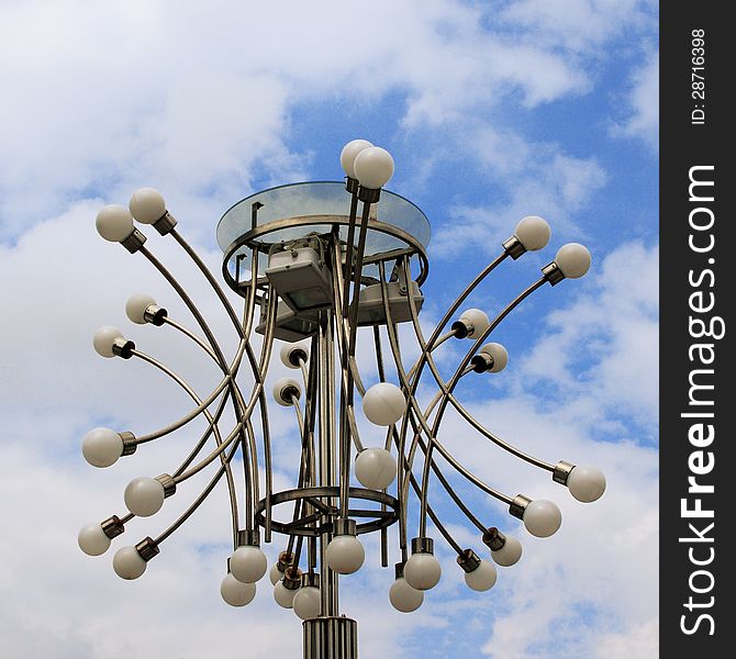 Modern street lantern against the cloudy sky