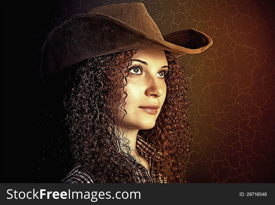 Art portrait of pretty curly girl cowboy