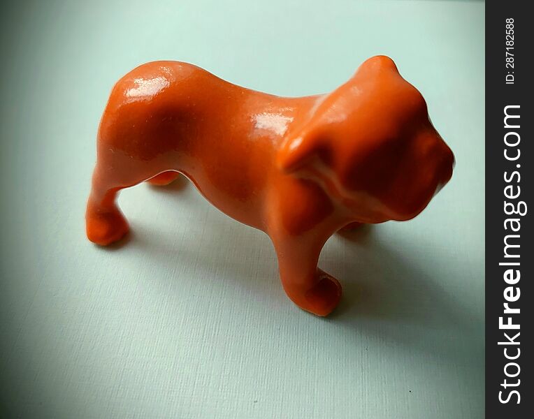 Ceramic Orange Bulldog Figurine On White Background