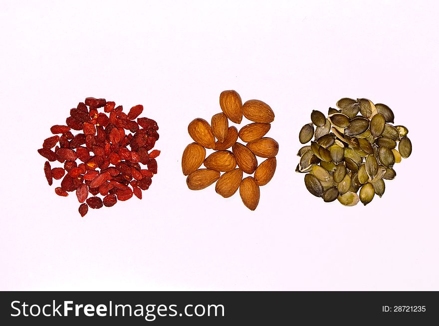 Mix of almonds, goji seeds and pumpkin seeds isolated on white. Mix of almonds, goji seeds and pumpkin seeds isolated on white