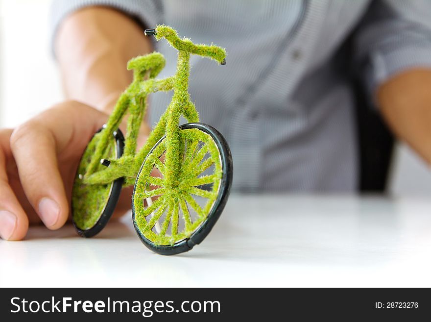 Hand holding eco bicycle concept