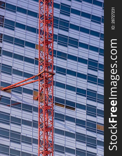 Vertical view of the crane attached to the skyscrapper under construction in the Warsaw downtown, Poland