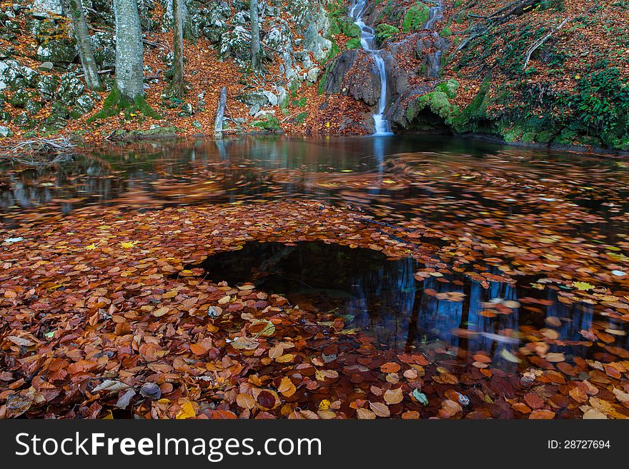 Beautiful autumn foliage, waterfalls and reflection patterns in mountain stream in the forest. Beautiful autumn foliage, waterfalls and reflection patterns in mountain stream in the forest