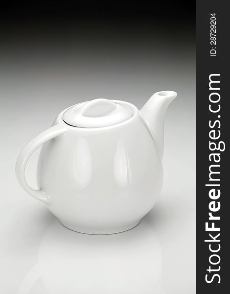 White porcelain teapot for preparation of hot invigorating drink.