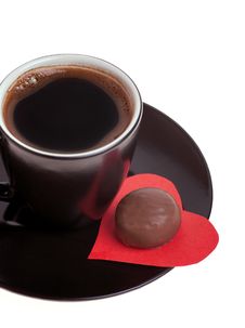 Chocolate Candy At The Heart Of Paper And Coffee Black Stock Images