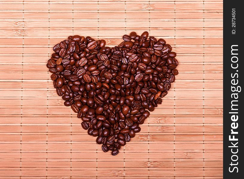 Heart of the coffee beans on a decorative straw