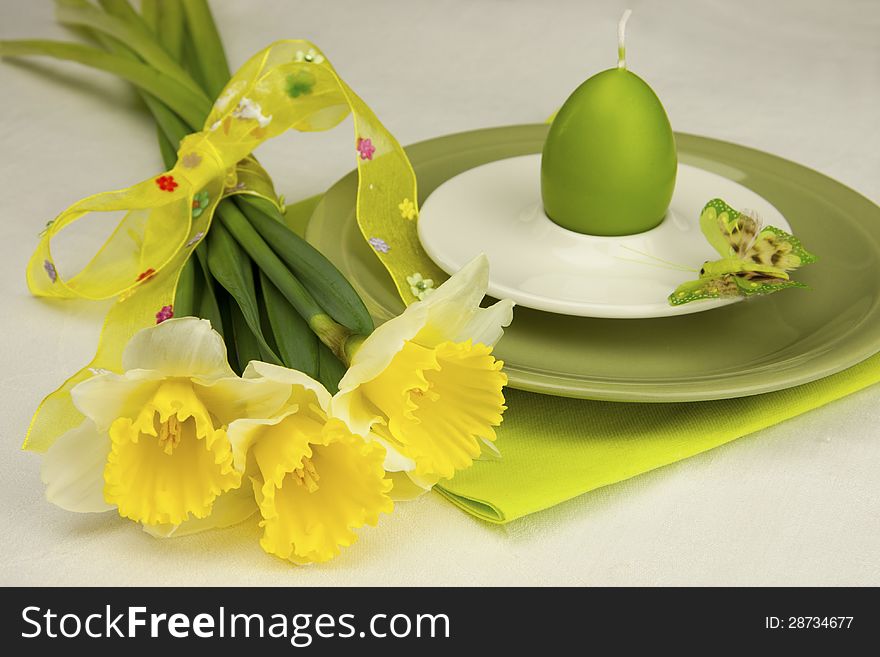 Easter composition with spring  flowers and color plate for eggs. Easter composition with spring  flowers and color plate for eggs