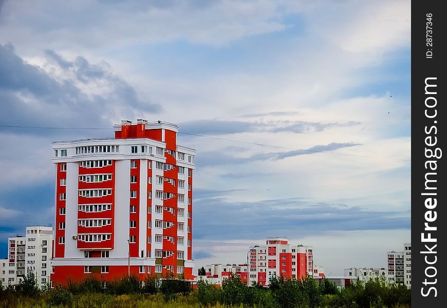 Buildings In A City In An Environment Of Green Trees. Buildings In A City In An Environment Of Green Trees