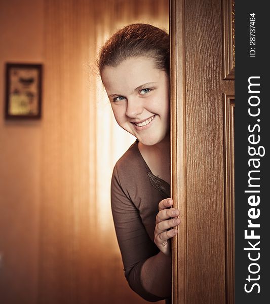 Beautiful Girl Peeking Behind The Door. Beautiful Girl Peeking Behind The Door