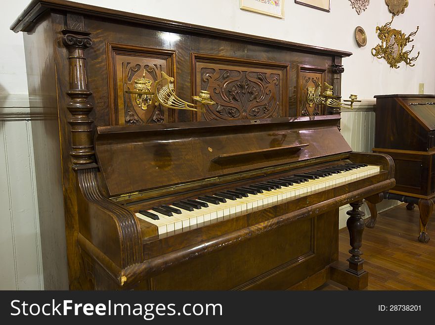 An antique piano in a showing detail. An antique piano in a showing detail