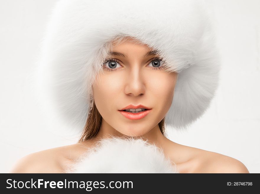 Fashion portrait of young beautiful woman posing on white background