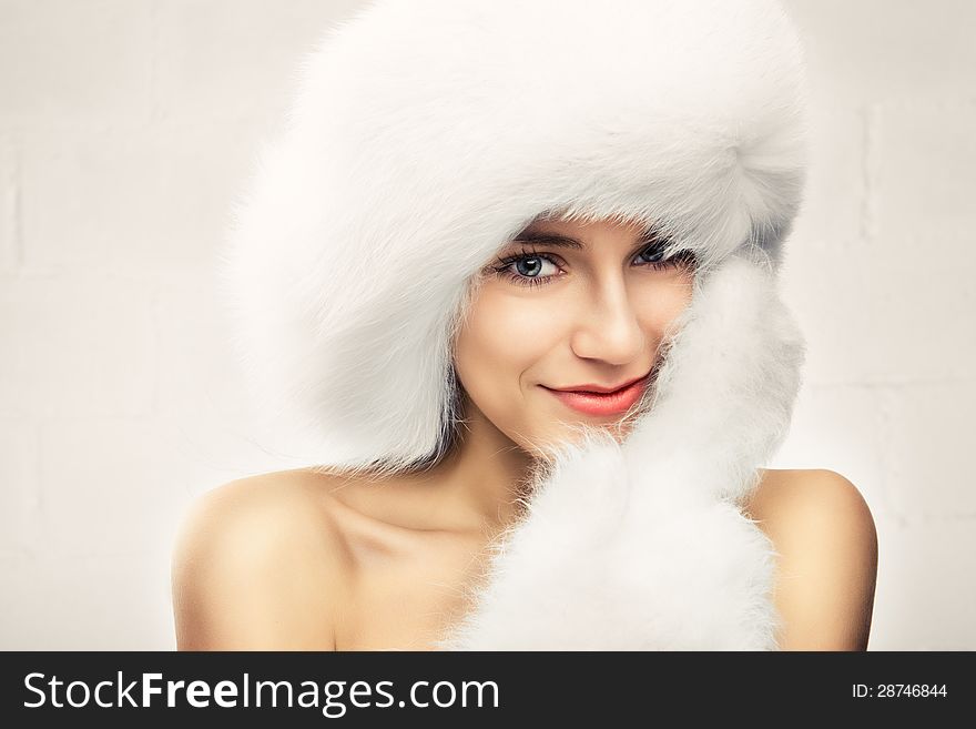 Fashion portrait of young beautiful woman posing on white background