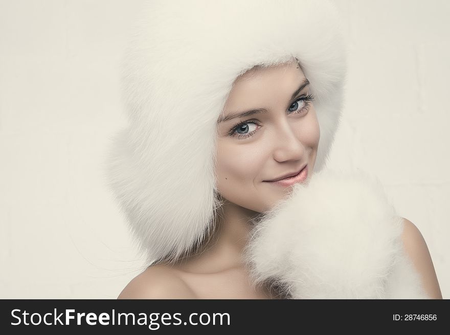 Fashion portrait of young beautiful woman posing on white background