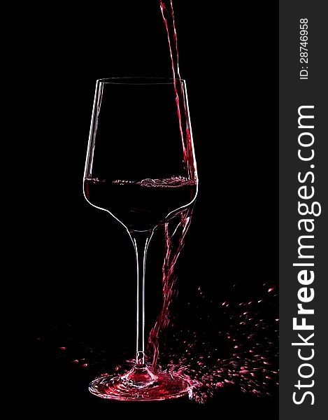 Red wine splashing in a glass.Close up. Red wine splashing in a glass.Close up