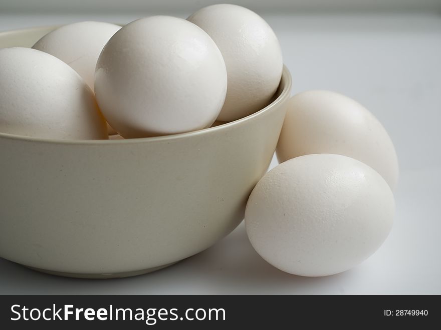 A bowl of eggs on white background