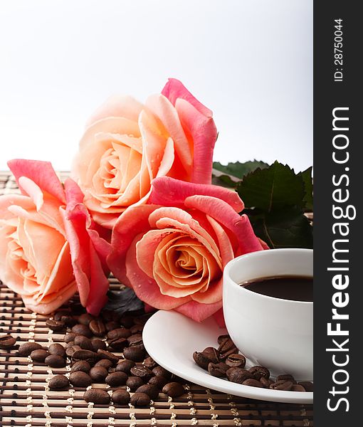 Flowers, cup of coffee and rose Close up on the fabric background.