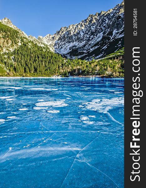 Mountain ice lake with cracked textured ice, High Tatras, Slovakia