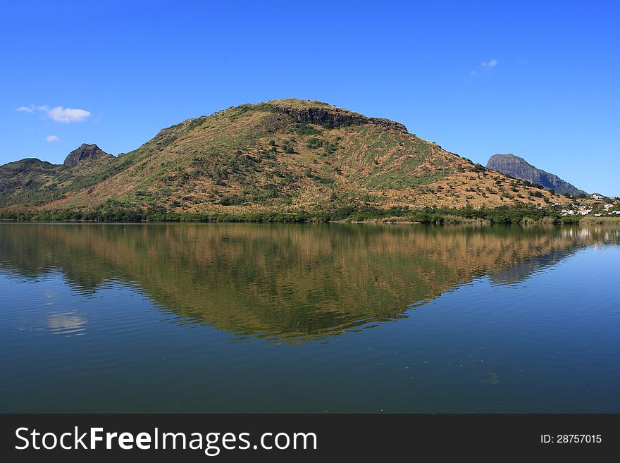 Image of a mountain reflectd in a fresh water lake. Vibrant blue sky. Image of a mountain reflectd in a fresh water lake. Vibrant blue sky.
