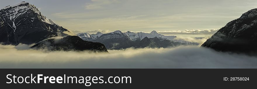 Morning view of Canadian Rockies under cloud cover in Banff, Canda. Morning view of Canadian Rockies under cloud cover in Banff, Canda