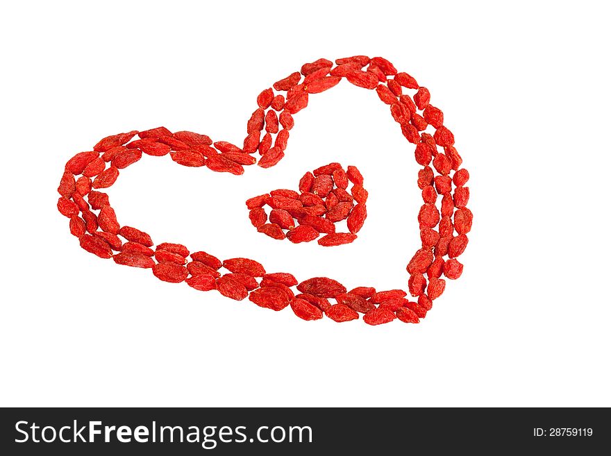 Goji berries heart shaped on white