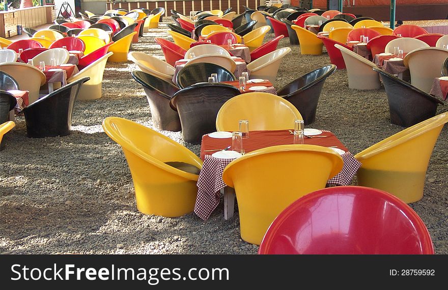 Colourful Tables and chairs arranged for outdoor service. Colourful Tables and chairs arranged for outdoor service