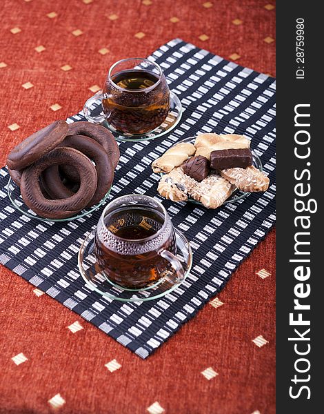 Two cups of tea with two plates with cookies studio shot