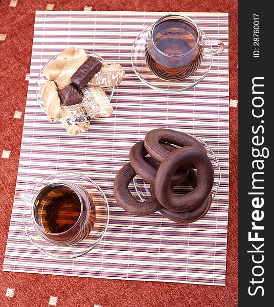 Two cups of tea with two plates with cookies