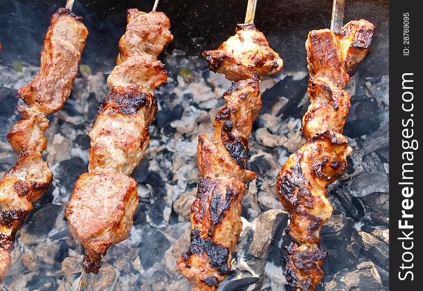 Delicious kebab fried on a grill outdoors. Delicious kebab fried on a grill outdoors