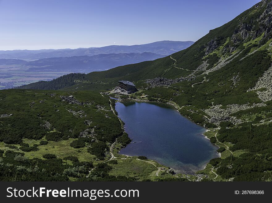 Scenic view of lake and mountains against clear sky