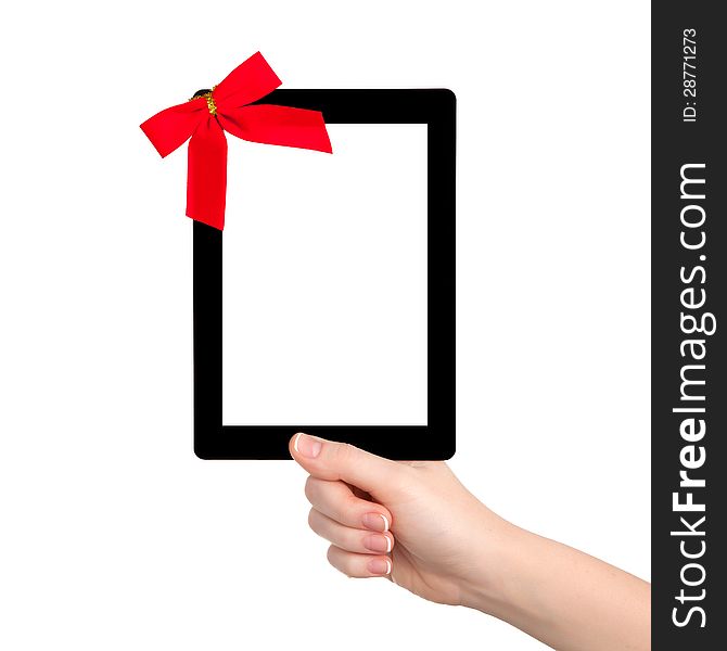 Female hands holding a tablet touch computer gadget with isolated screen and a red gift bow. Female hands holding a tablet touch computer gadget with isolated screen and a red gift bow