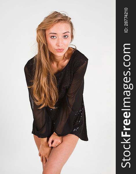 Portrait of beautiful sexy young woman dancing in studio. Closeup on a white background.