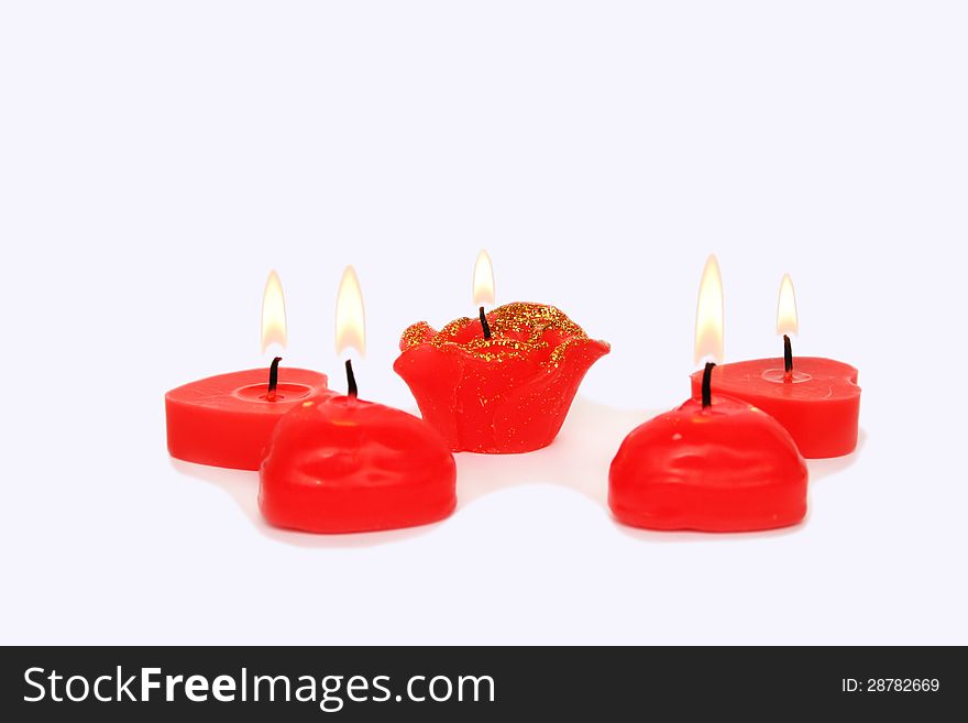 Red candles on grey background.