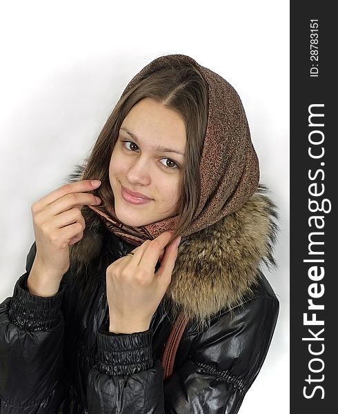 Portrait of happy smiling girl in leather coat with fur collar and brown headscarf on bright background. Portrait of happy smiling girl in leather coat with fur collar and brown headscarf on bright background.