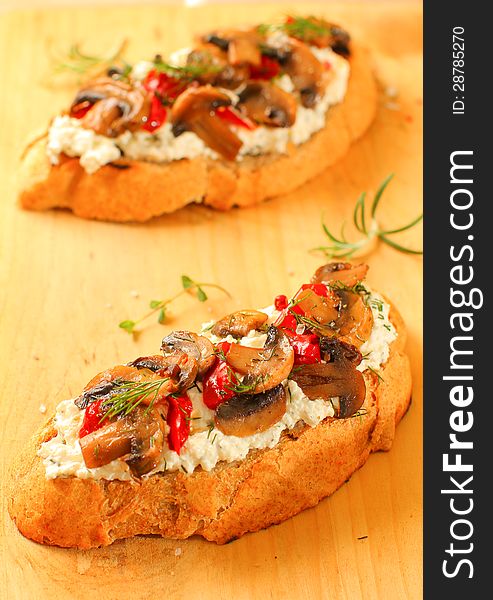Appetizer with roasted mushrooms, red peppers and cream cheese on rustic bread. Appetizer with roasted mushrooms, red peppers and cream cheese on rustic bread
