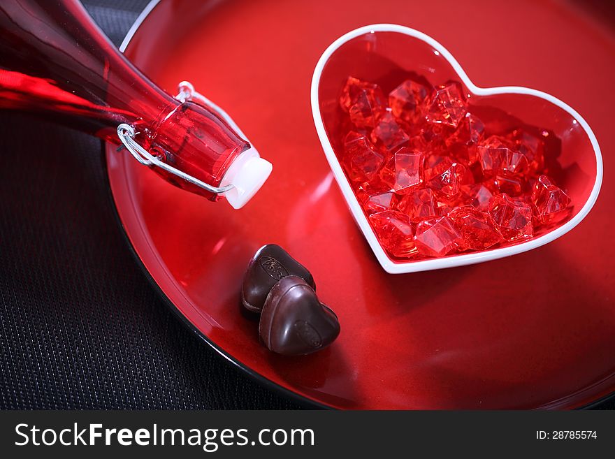 Red glass heart on a plate. Red glass heart on a plate.