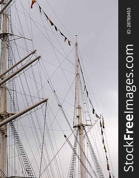 Mast of an old warship reaching for the sky and clouds. Mast of an old warship reaching for the sky and clouds.