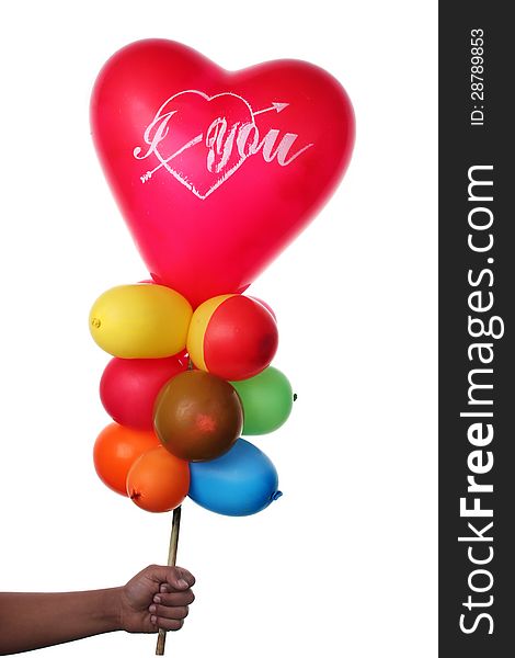 Boy holding colorful balloons with heart shape
