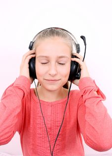 Blond Girl Listening To Music With Headset And Is Looking Forward Stock Photo Blond Girl Listening To Music With Headset And Is Looking Forward Stock Photo