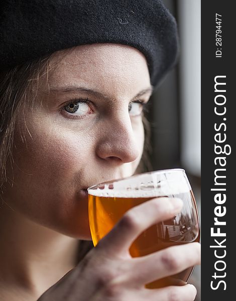 Portrait of a young woman with a glass of India Pale Ale. Portrait of a young woman with a glass of India Pale Ale