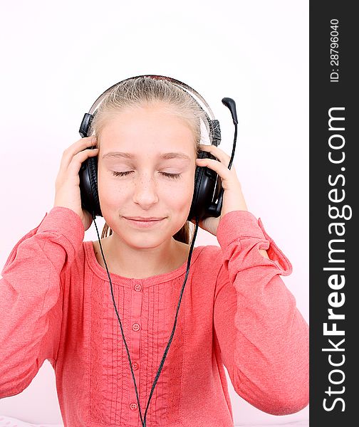 Blond girl listening to music with headphones and is looking forward