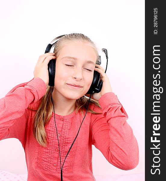 Blond happy girl listening to music with headset