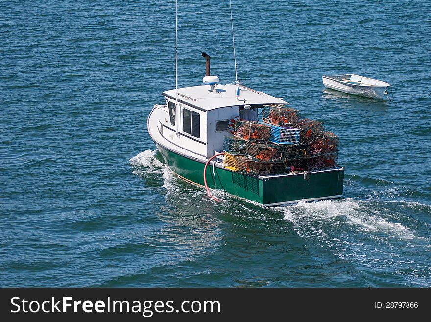Horizontal image of a lobster boat filled with cages . Horizontal image of a lobster boat filled with cages