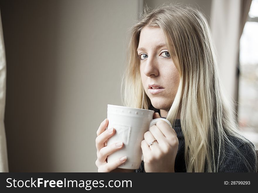 Young Woman Drinking Coffee