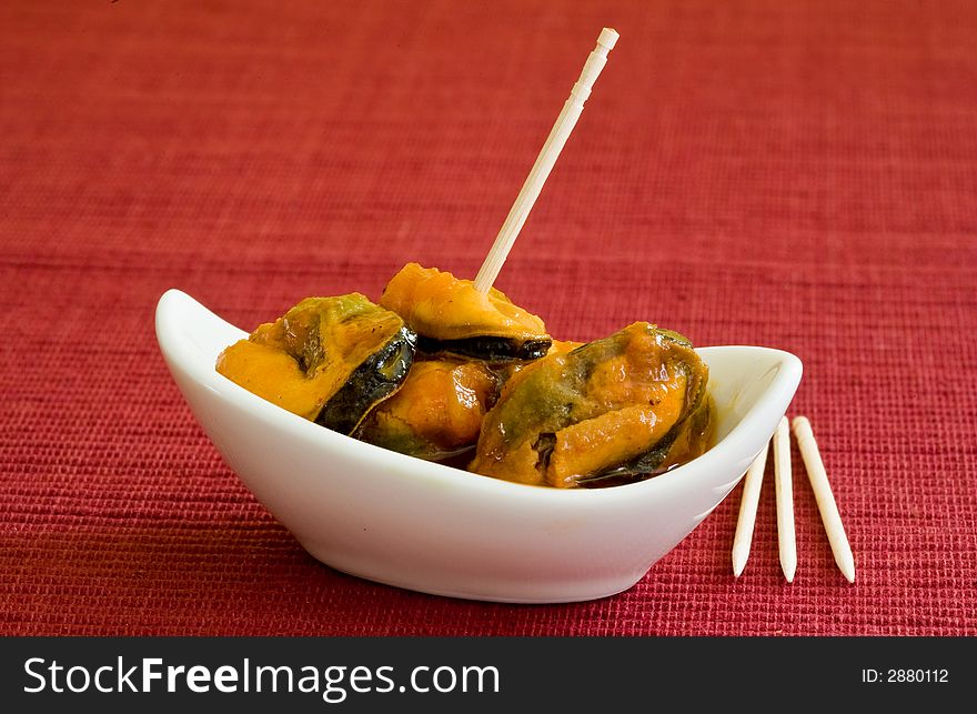 Mussel with seafood sauce on white little bowl. Mussel with seafood sauce on white little bowl