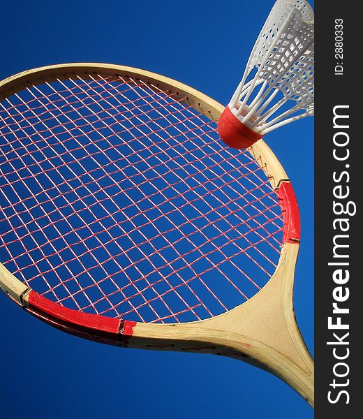 tennis racket with shuttlecock on blue background. tennis racket with shuttlecock on blue background