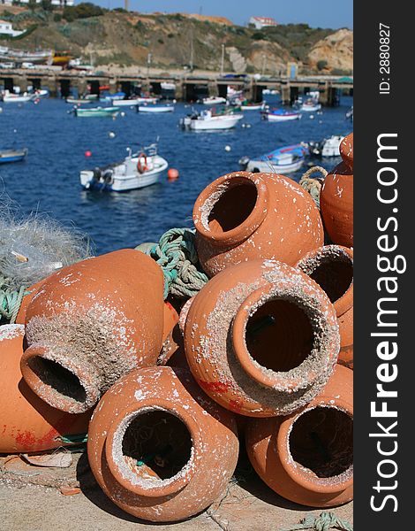 Fishing pots in terracotta with sea behind