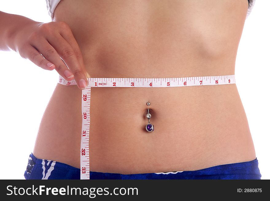 View of a girl measuring her waist. View of a girl measuring her waist