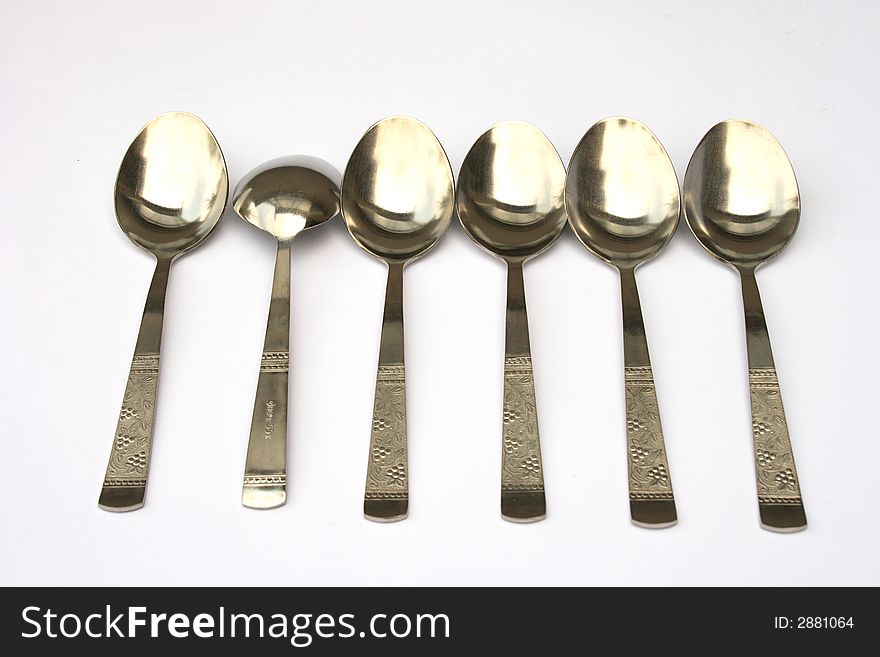 On a photo a line of spoons and one turned