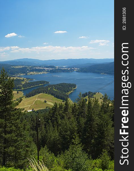 Summer mountain panorama with blue sky and lake. Summer mountain panorama with blue sky and lake