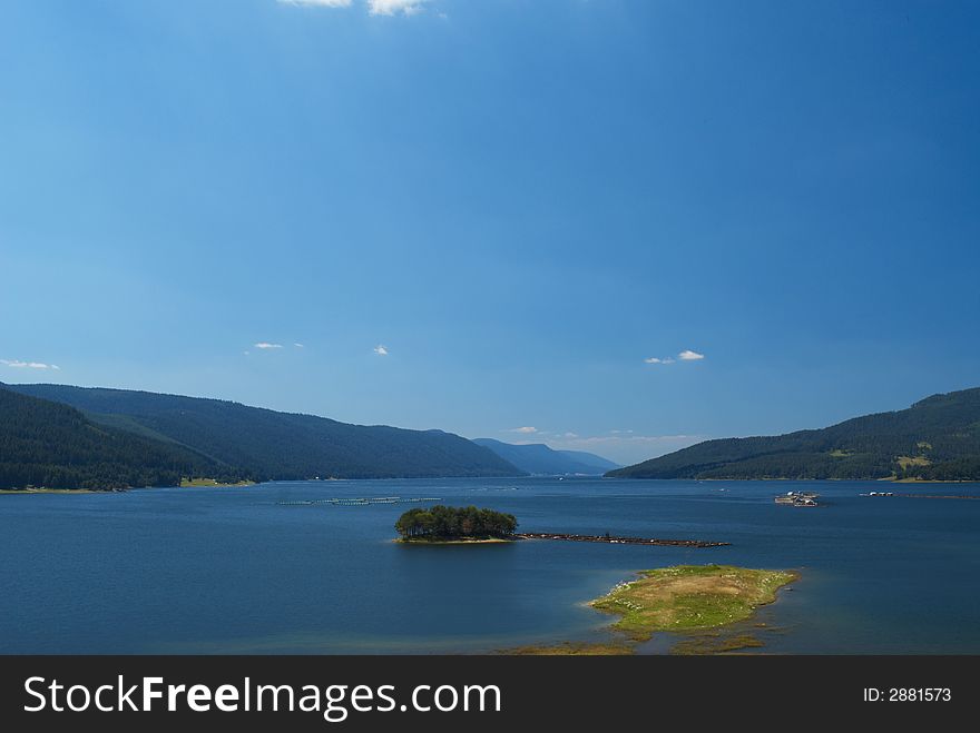 Summer mountain panorama with blue sky and lake. Summer mountain panorama with blue sky and lake